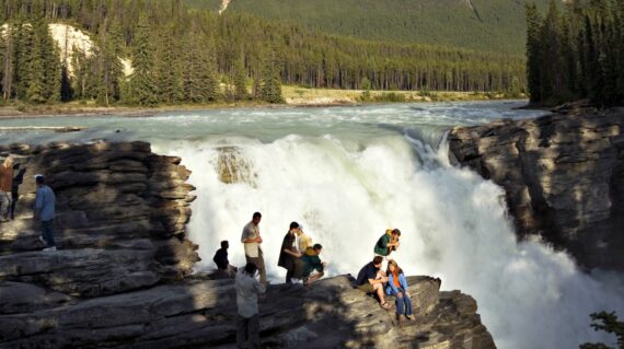 Athabasca Falls and river is one of many interesting spots in Canadian Rockies. In the back is Mount Kerkeslin