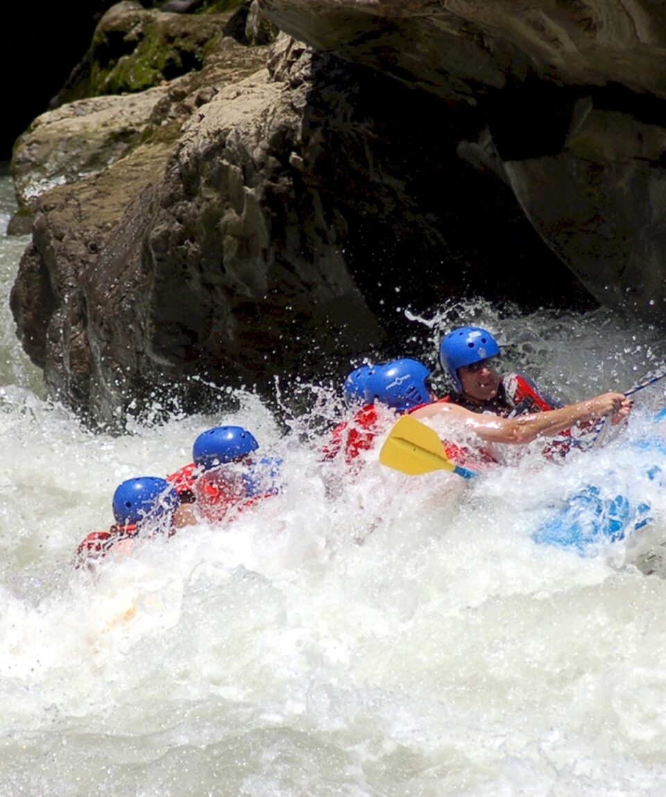 Rising from the waves. Whitewater rafting.